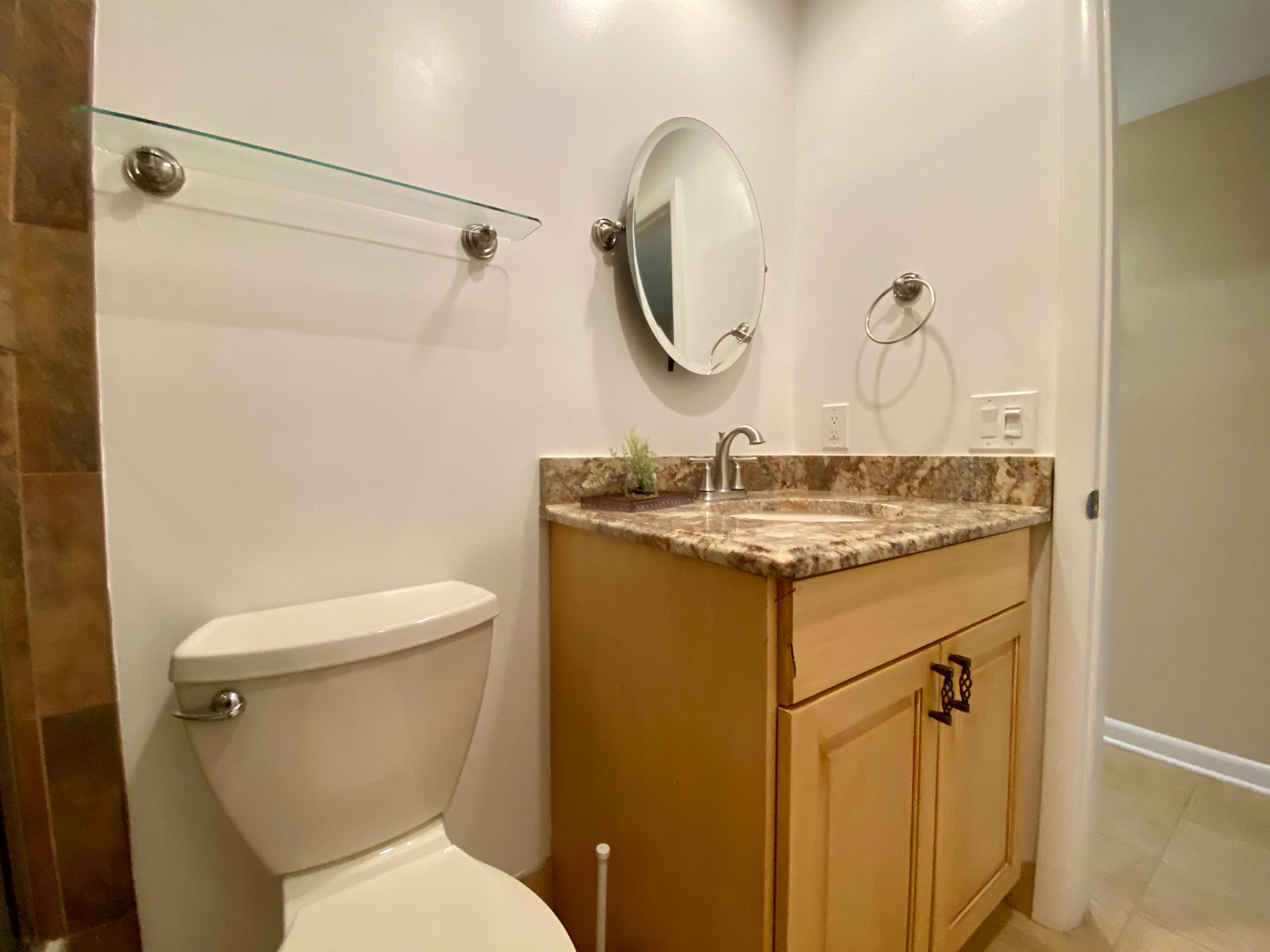 843 Flanders South Delray Beach, FL 33484 - Photo 11 of 29 a bathroom with a granite countertop sink toilet and shower