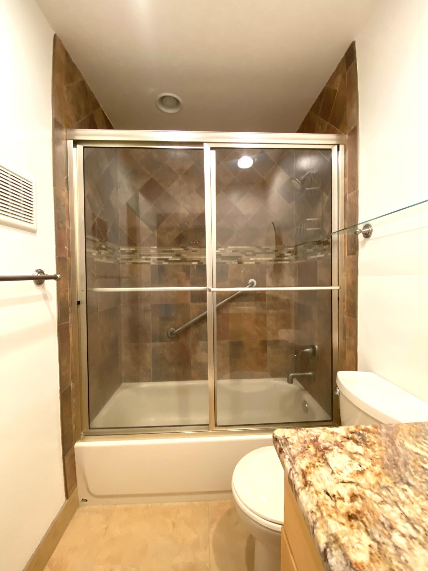 843 Flanders South Delray Beach, FL 33484 - Photo 12 of 29 a bathroom with a bathtub and shower