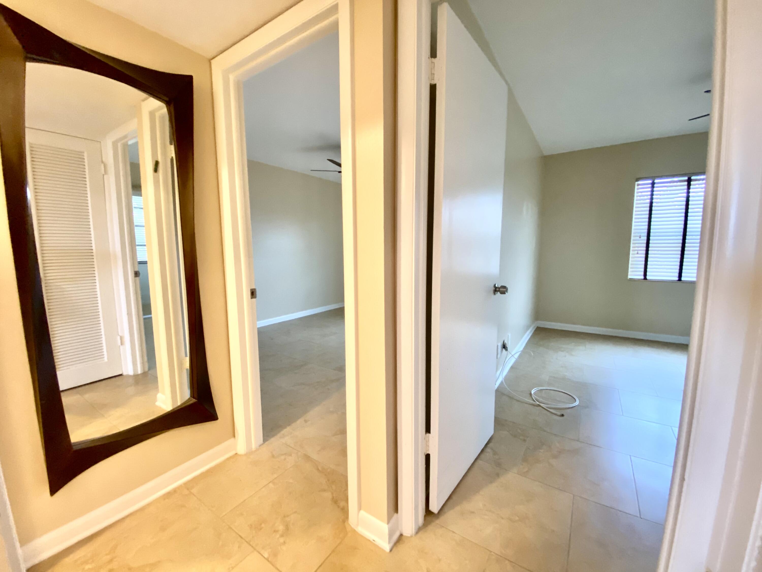 843 Flanders South Delray Beach, FL 33484 - Photo 13 of 29 a view of a bathroom from a corridor