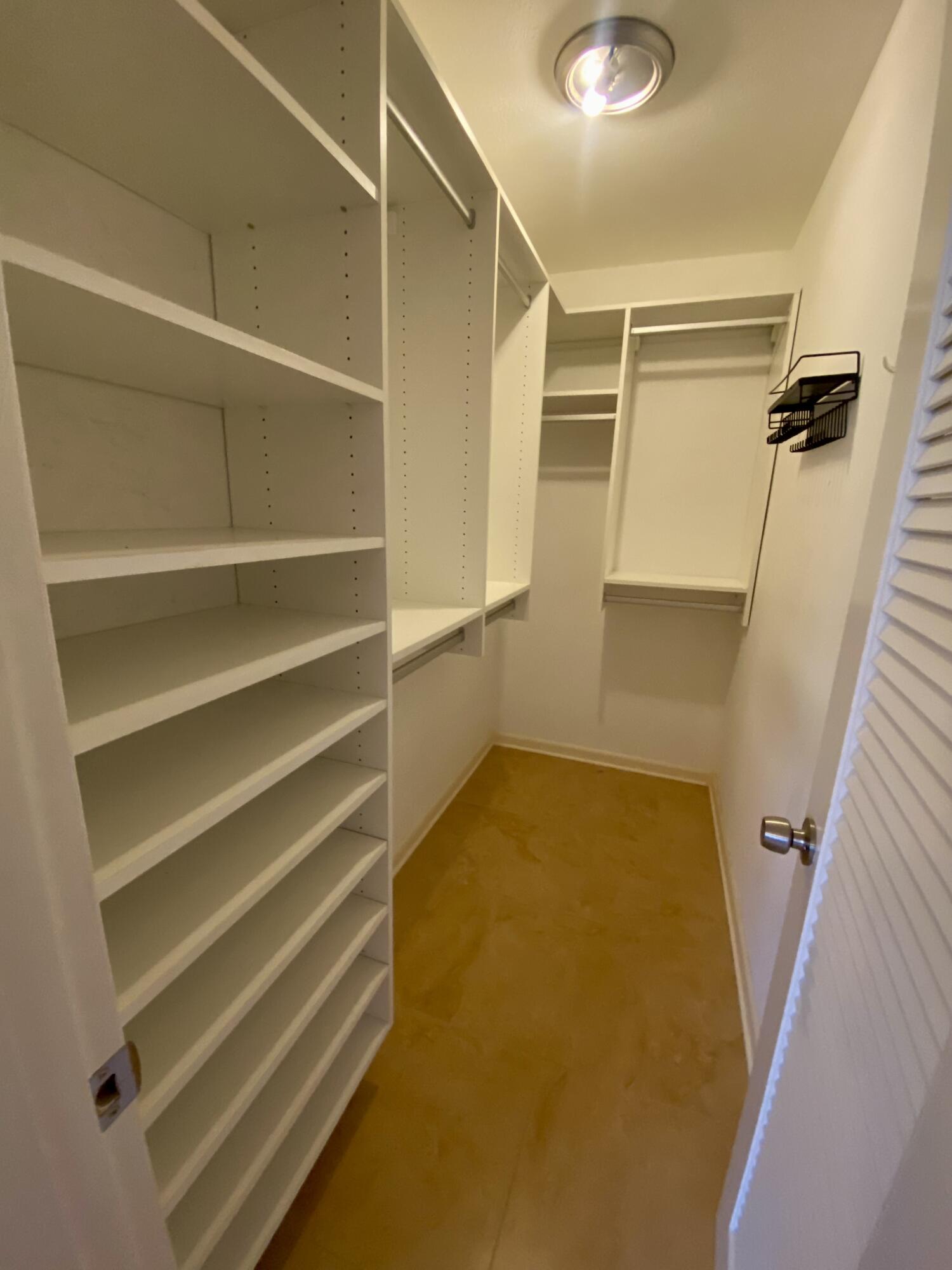 843 Flanders South Delray Beach, FL 33484 - Photo 16 of 29 a view of walk in closet with empty racks