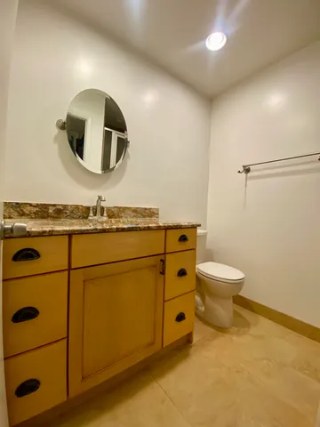 a bathroom with a toilet a sink and mirror