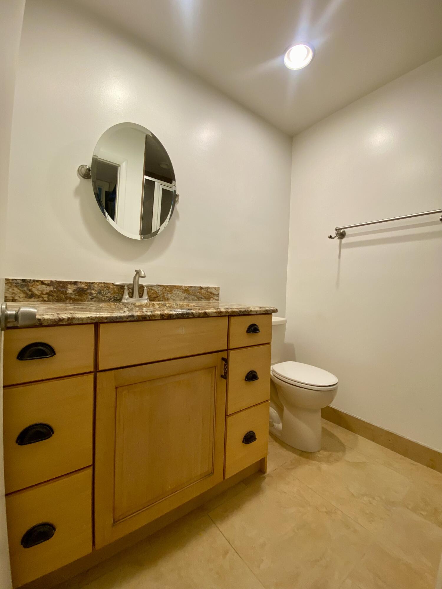 843 Flanders South Delray Beach, FL 33484 - Photo 17 of 29 a bathroom with a toilet a sink and mirror