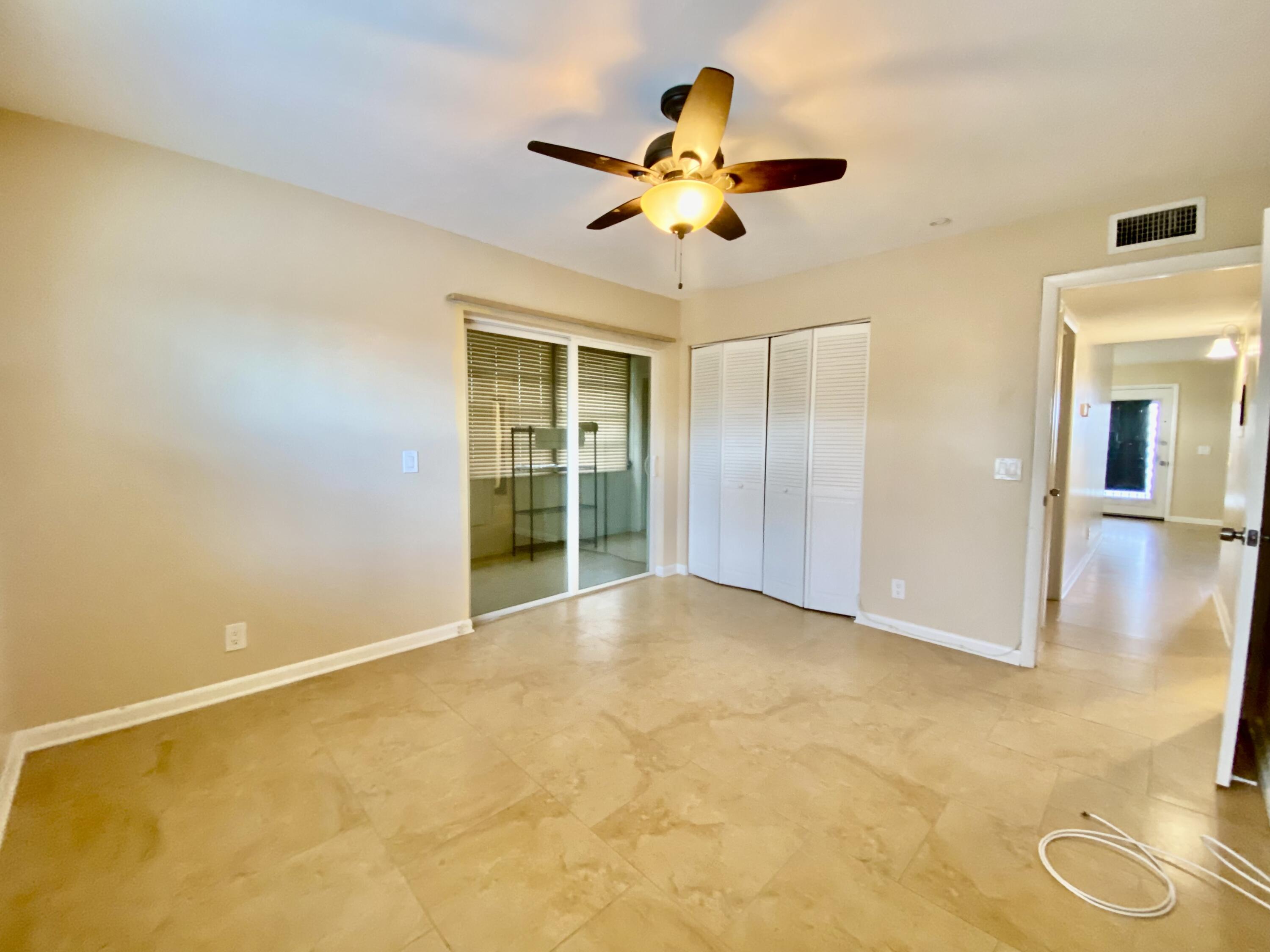 843 Flanders South Delray Beach, FL 33484 - Photo 19 of 29 an empty room with a ceiling fan and a window