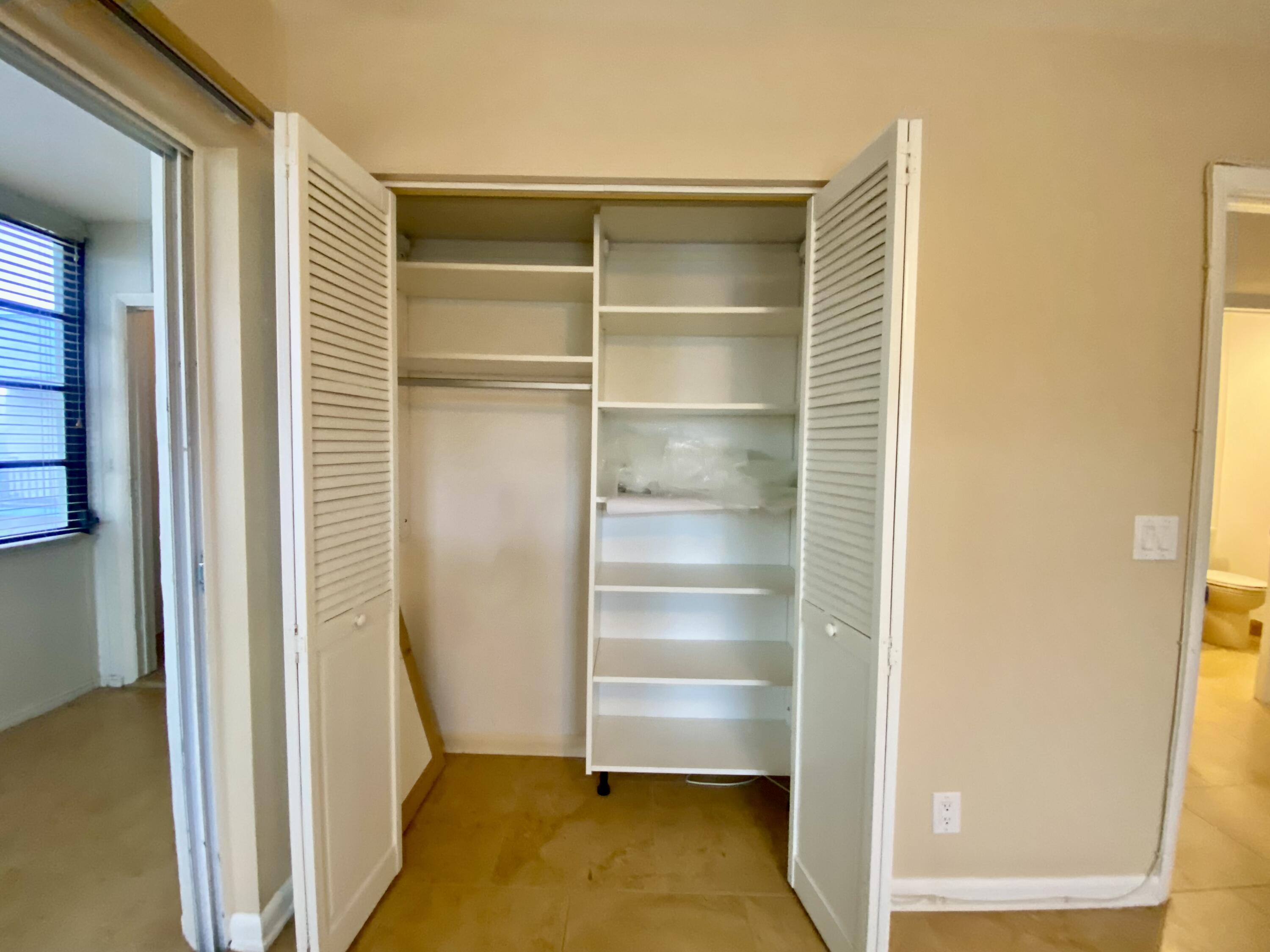 843 Flanders South Delray Beach, FL 33484 - Photo 21 of 29 a view of walk in closet with empty racks