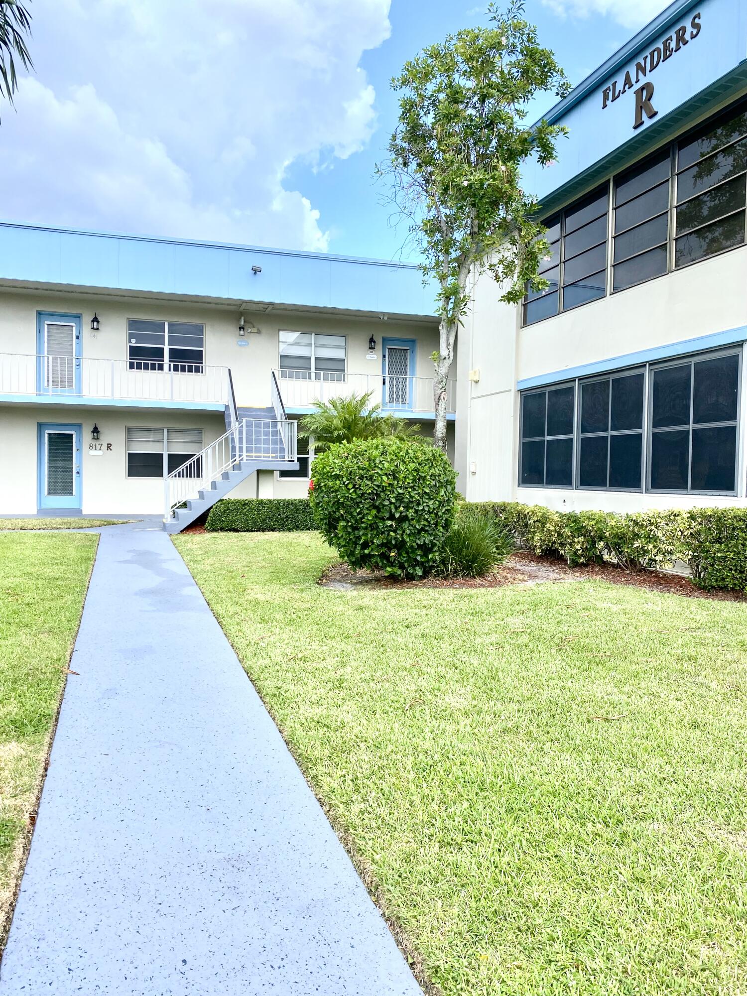 843 Flanders South Delray Beach, FL 33484 - Photo 24 of 29 a front view of a house with a yard and potted plants