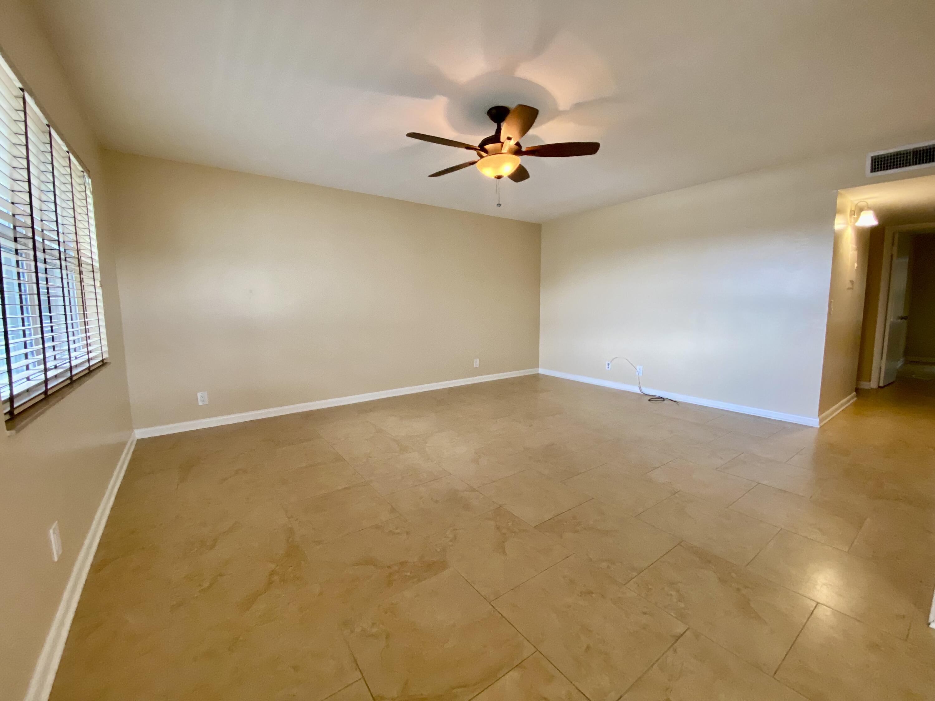 843 Flanders South Delray Beach, FL 33484 - Photo 7 of 29 wooden floor in an empty room with a window