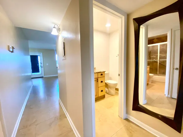 a view of a bathroom from a hallway