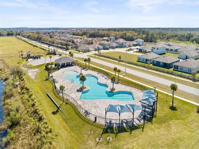 an aerial view of residential houses with outdoor space