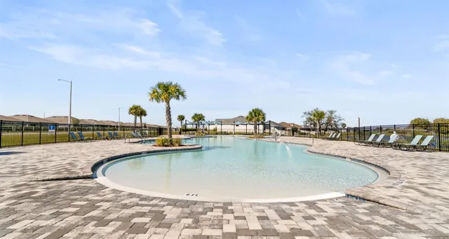 a view of a swimming pool with a lounge chair