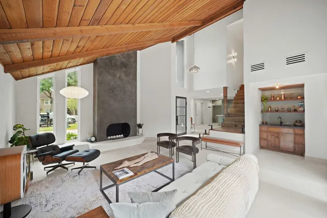 a living room with furniture a fireplace and a table