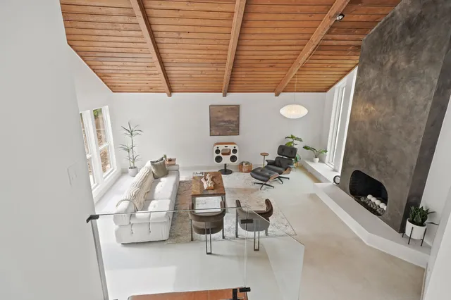 a view of living room with furniture and a fireplace