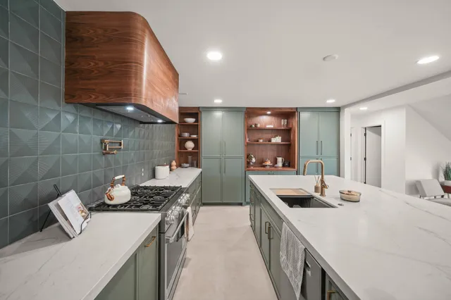 a kitchen that has a sink and a stove