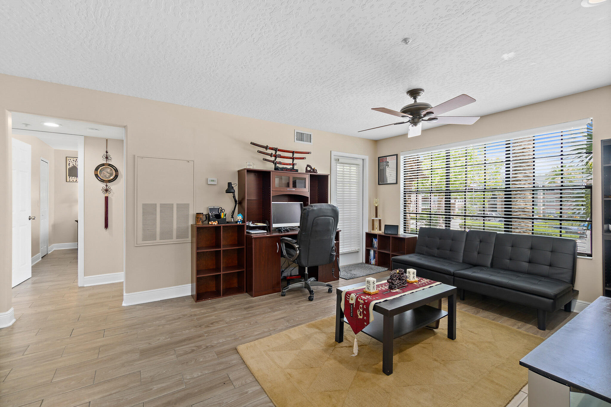 7667 North Wickham Road, Unit 511 Melbourne, FL 32940 - Photo 11 of 48 a living room with furniture and a flat screen tv