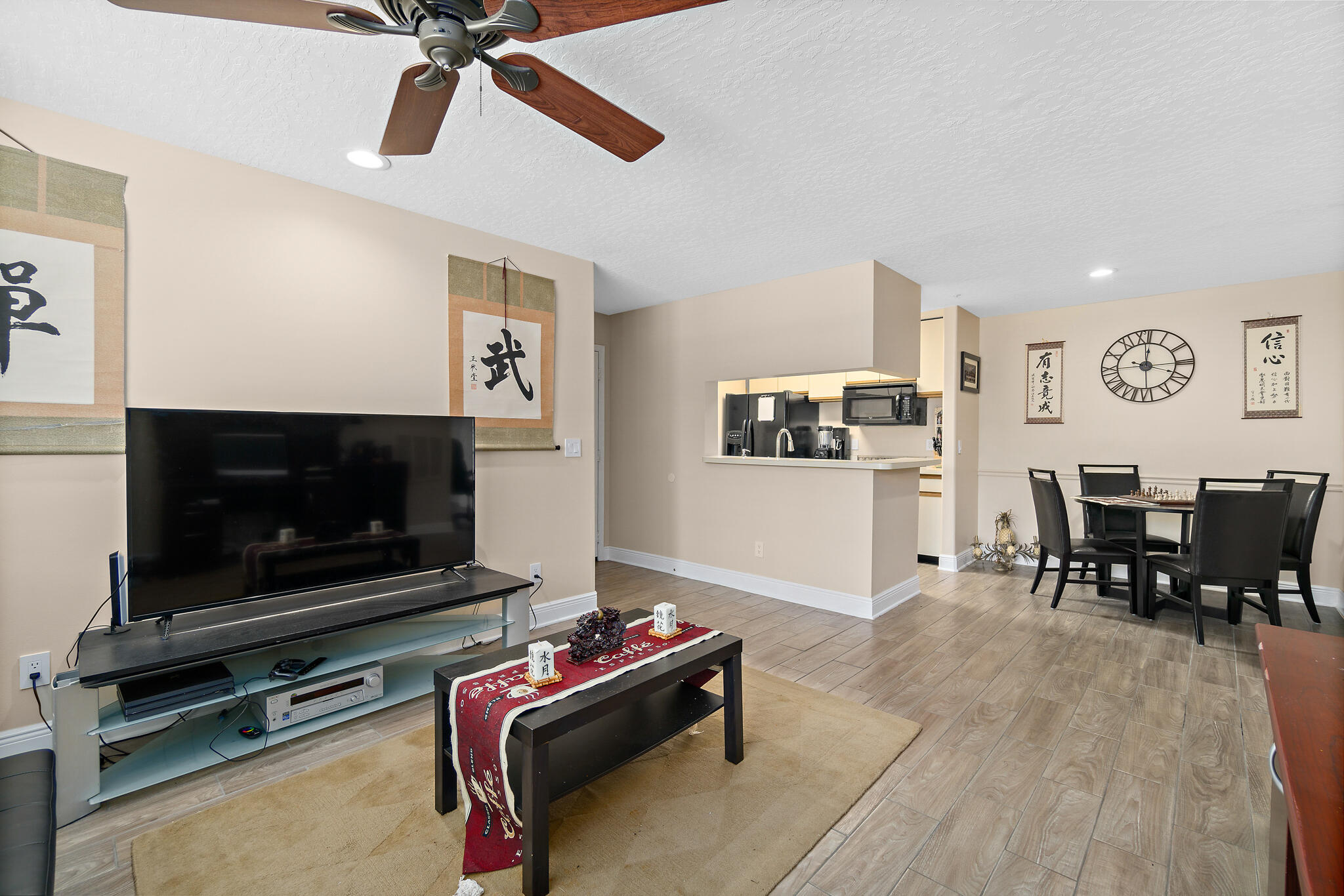 7667 North Wickham Road, Unit 511 Melbourne, FL 32940 - Photo 13 of 48 a living room with furniture and a flat screen tv