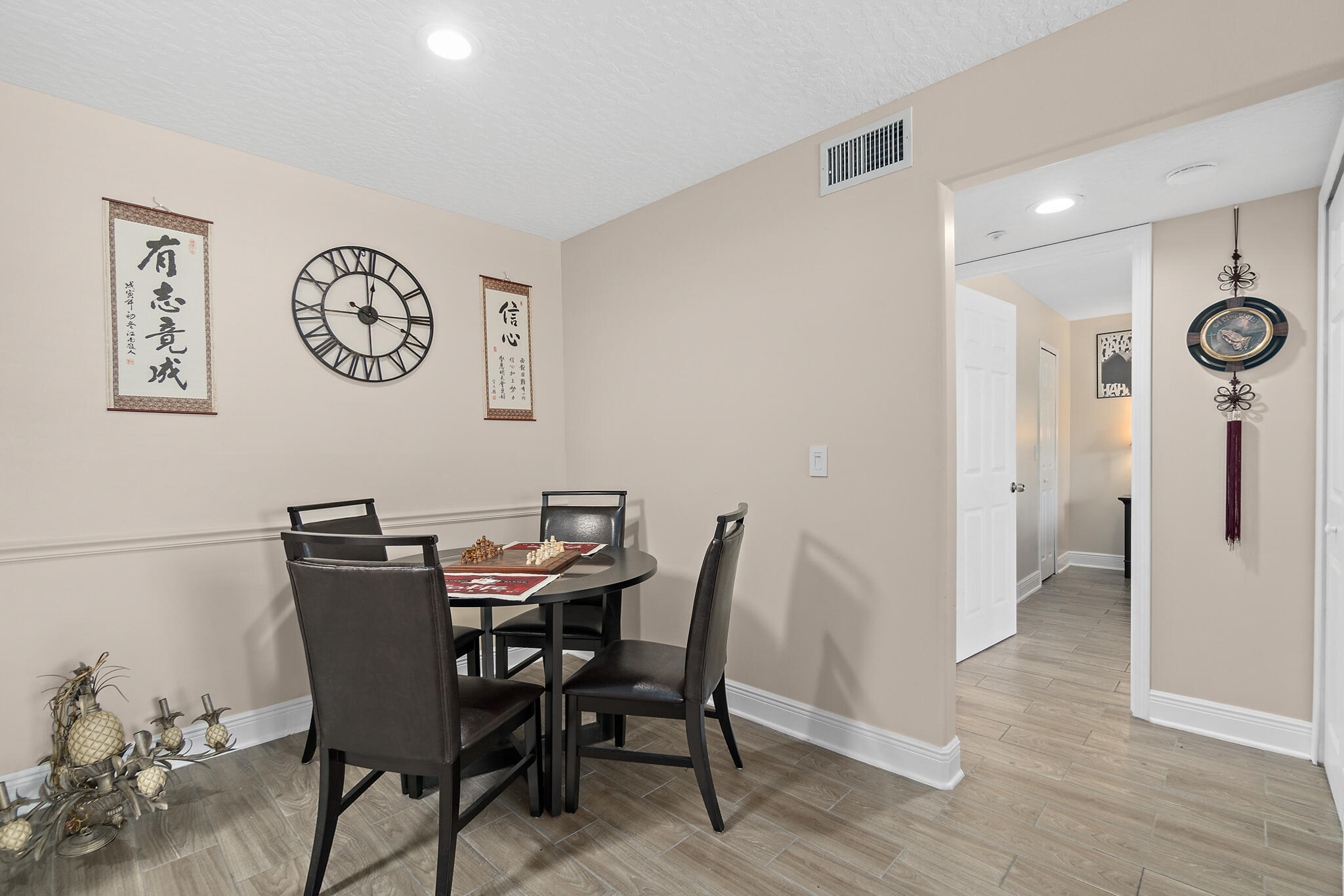 7667 North Wickham Road, Unit 511 Melbourne, FL 32940 - Photo 14 of 48 a view of a dining room with furniture and wooden floor