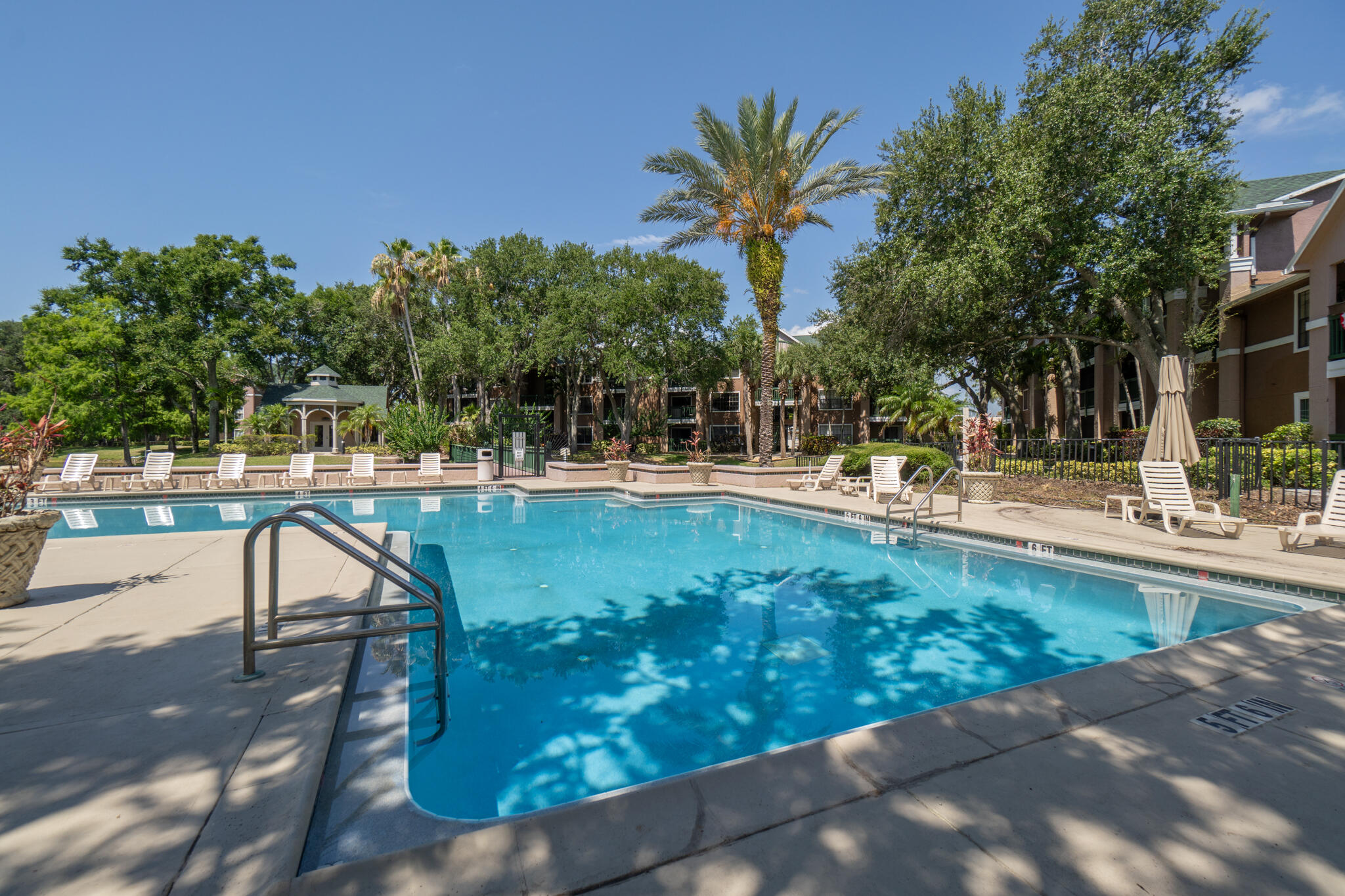 7667 North Wickham Road, Unit 511 Melbourne, FL 32940 - Photo 17 of 48 a swimming pool with outdoor seating and yard