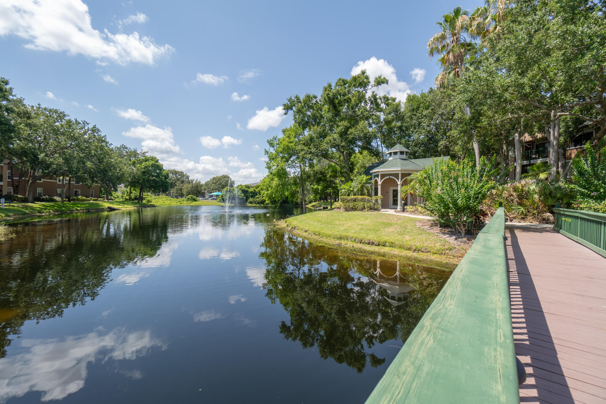 7667 North Wickham Road, Unit 511 Melbourne, FL 32940 - Photo 20 of 48 a view of a lake with a yard