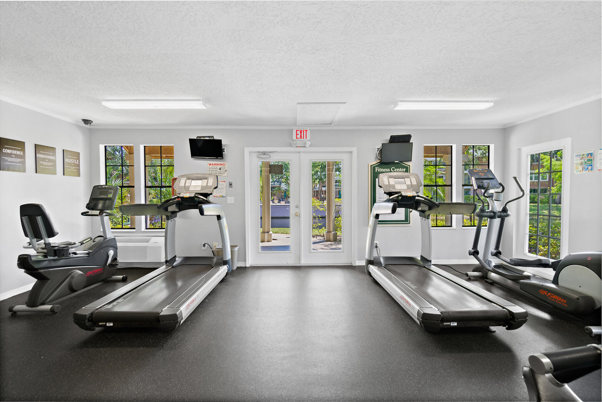 7667 North Wickham Road, Unit 511 Melbourne, FL 32940 - Photo 23 of 48 a room with gym equipment and a large window