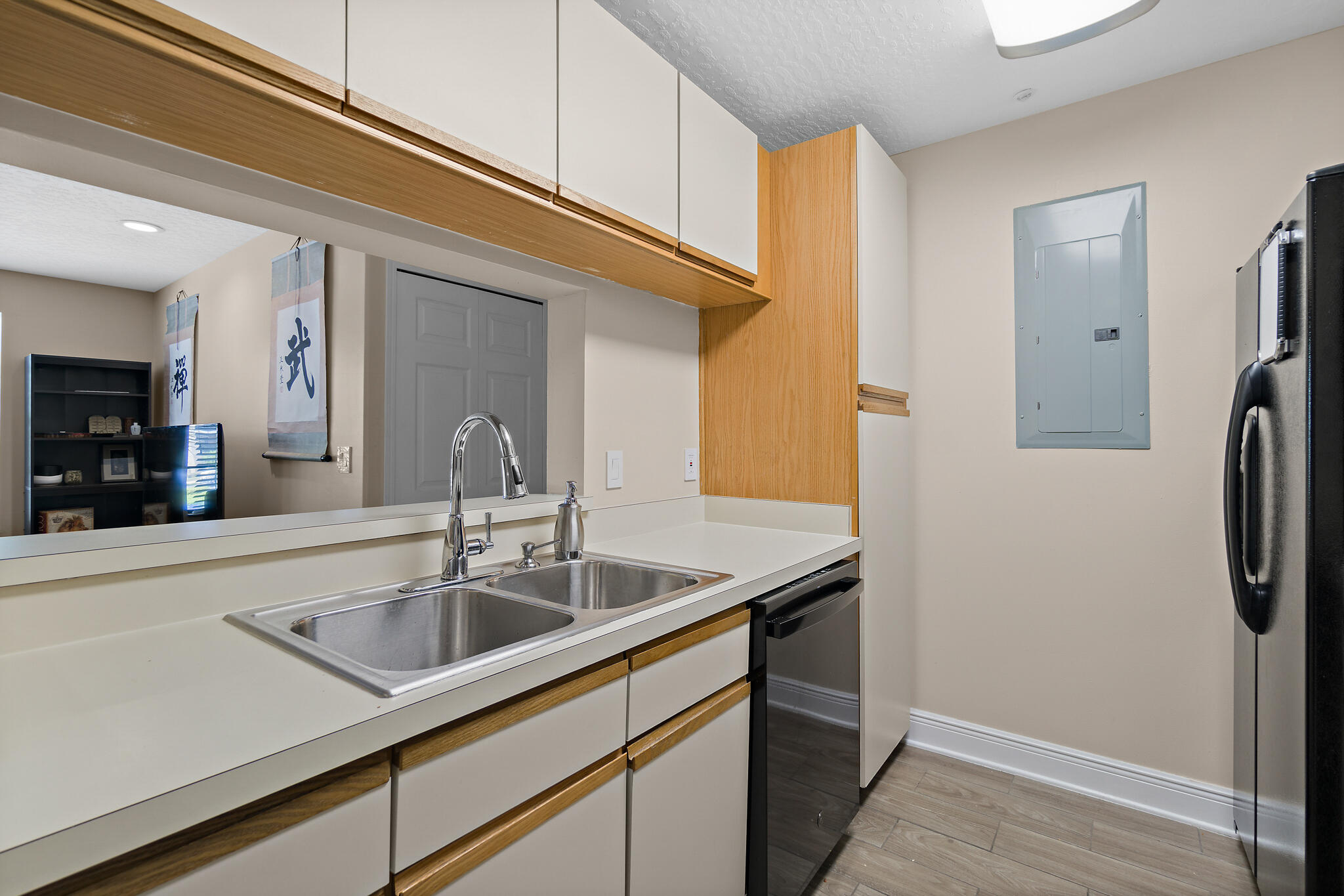 7667 North Wickham Road, Unit 511 Melbourne, FL 32940 - Photo 25 of 48 a kitchen with a sink and refrigerator