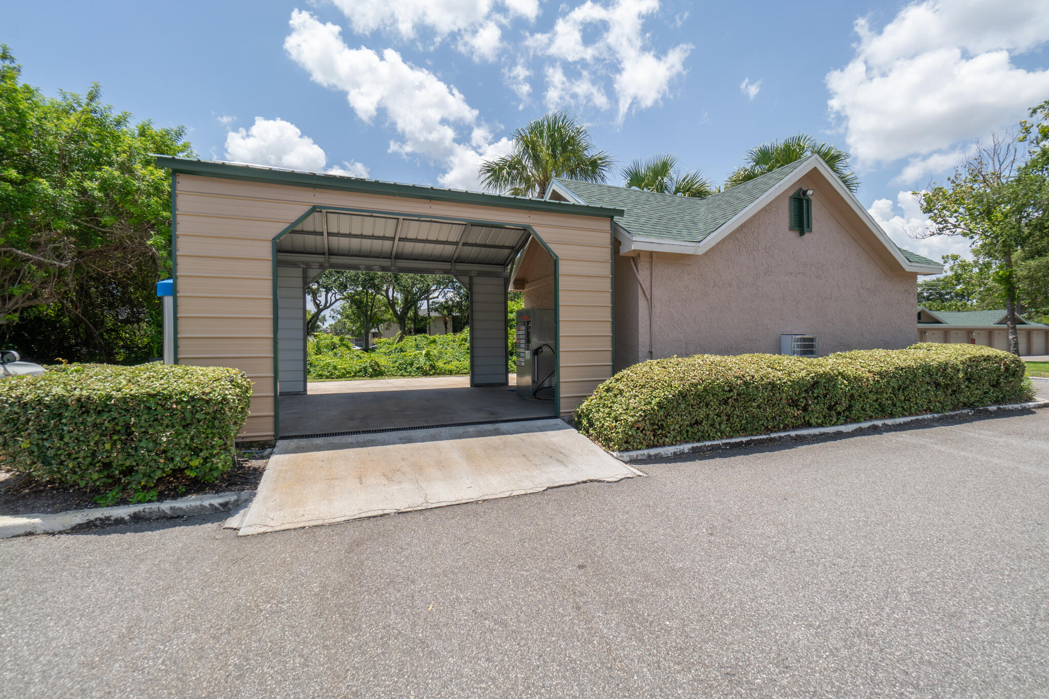 7667 North Wickham Road, Unit 511 Melbourne, FL 32940 - Photo 35 of 48 a view of a house with porch and a garden