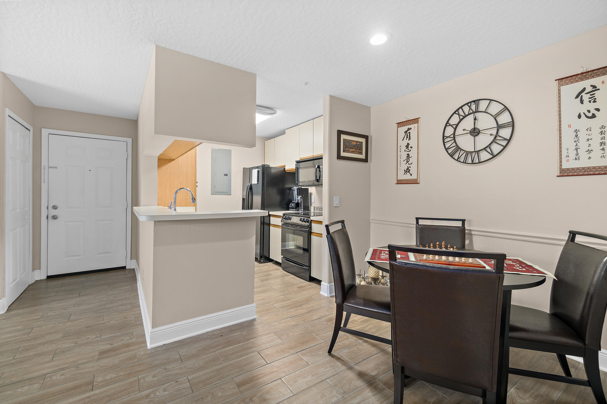 7667 North Wickham Road, Unit 511 Melbourne, FL 32940 - Photo 7 of 48 a view of a dining room with furniture and wooden floor