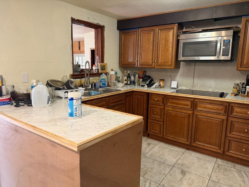 4050 Old Anson Road Abilene, TX 79601 - Photo 15 of 40 a kitchen with sink cabinets and microwave