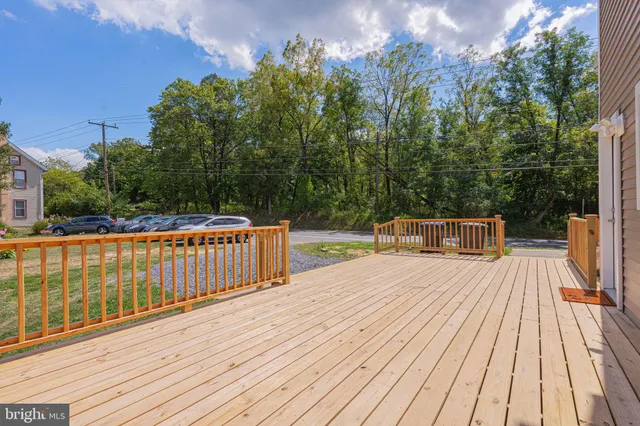 a balcony with wooden floor and fence