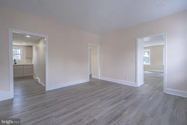 a view of an empty room and wooden floor