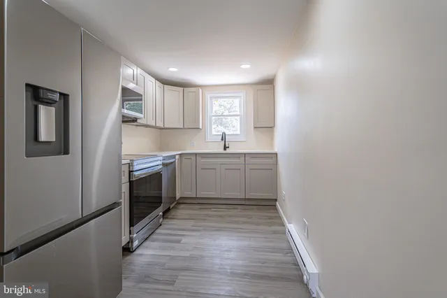 a kitchen with a sink a stove and cabinets