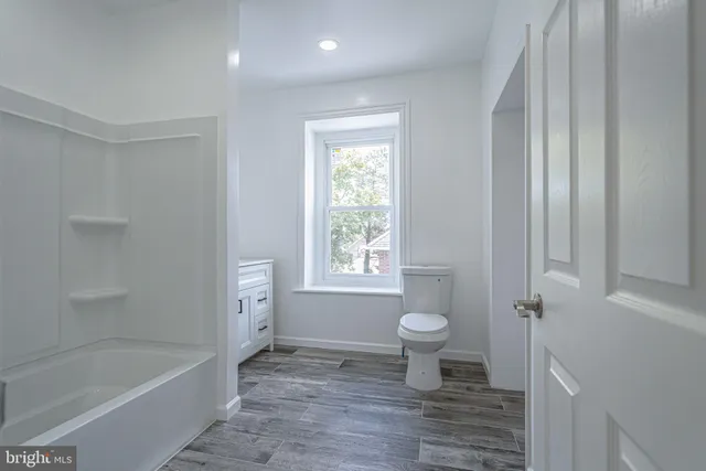 a bathroom with a bathtub toilet and sink