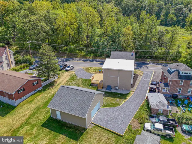 an aerial view of a house with swimming pool and garden