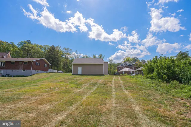 a view of a big yard with an outdoor space and seating