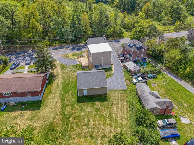 an aerial view of house with yard swimming pool and outdoor seating