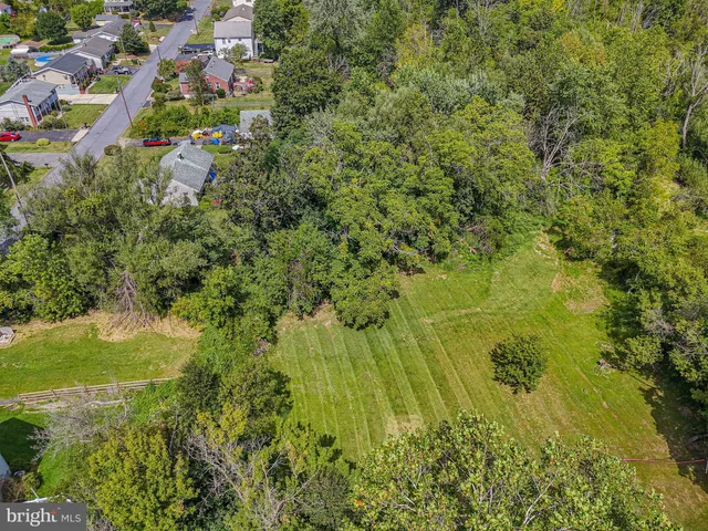 an aerial view of house with yard swimming pool and outdoor seating
