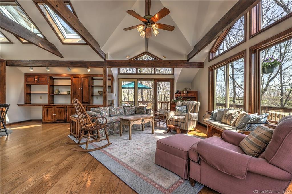 200 Porters Hill Road Trumbull, CT 06611 - Photo 1 of 1 a living room with furniture a fireplace and a large window