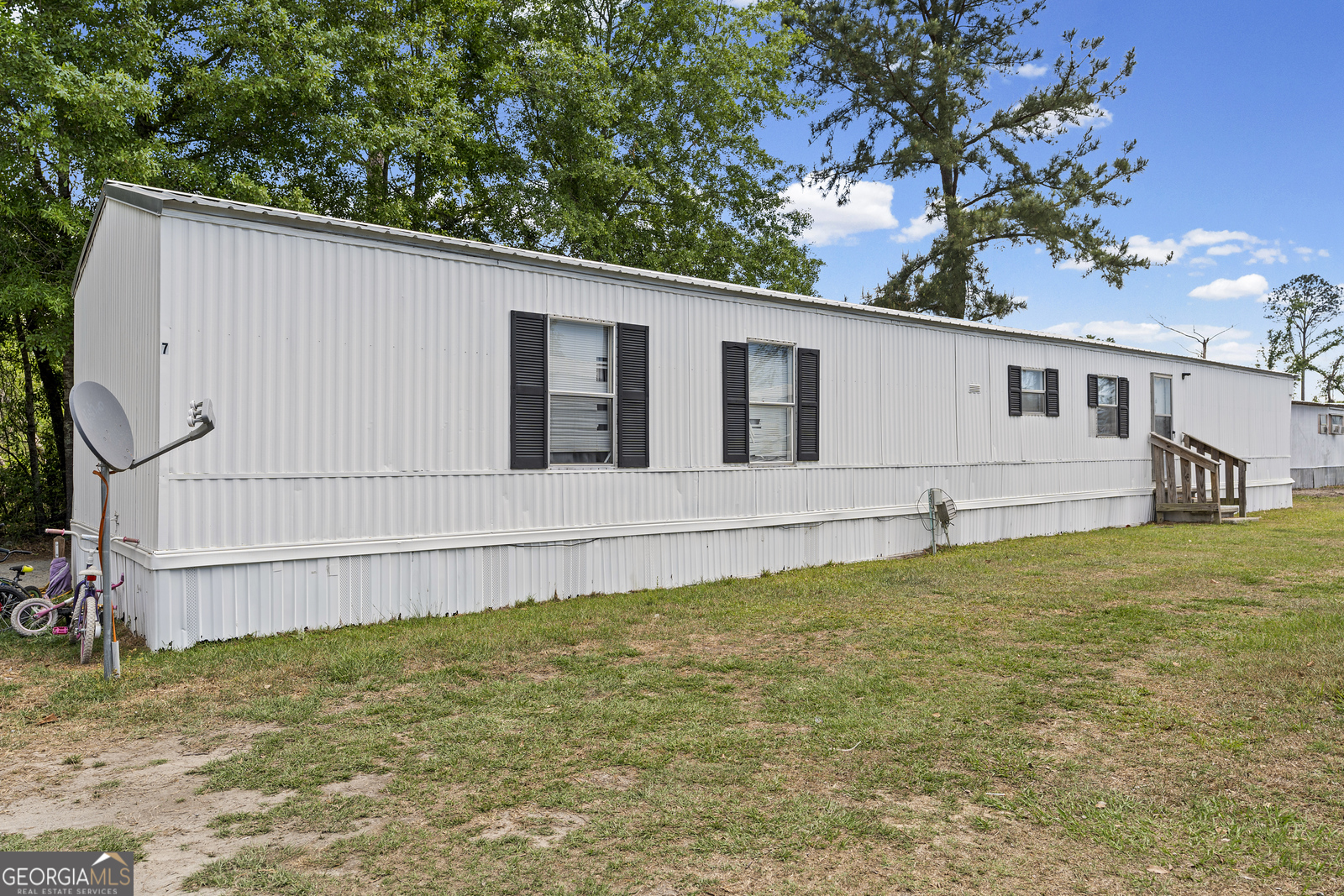 227 Bell Telephone Road Hazlehurst, GA 31539 - Photo 2 of 20 a house with trees in the background