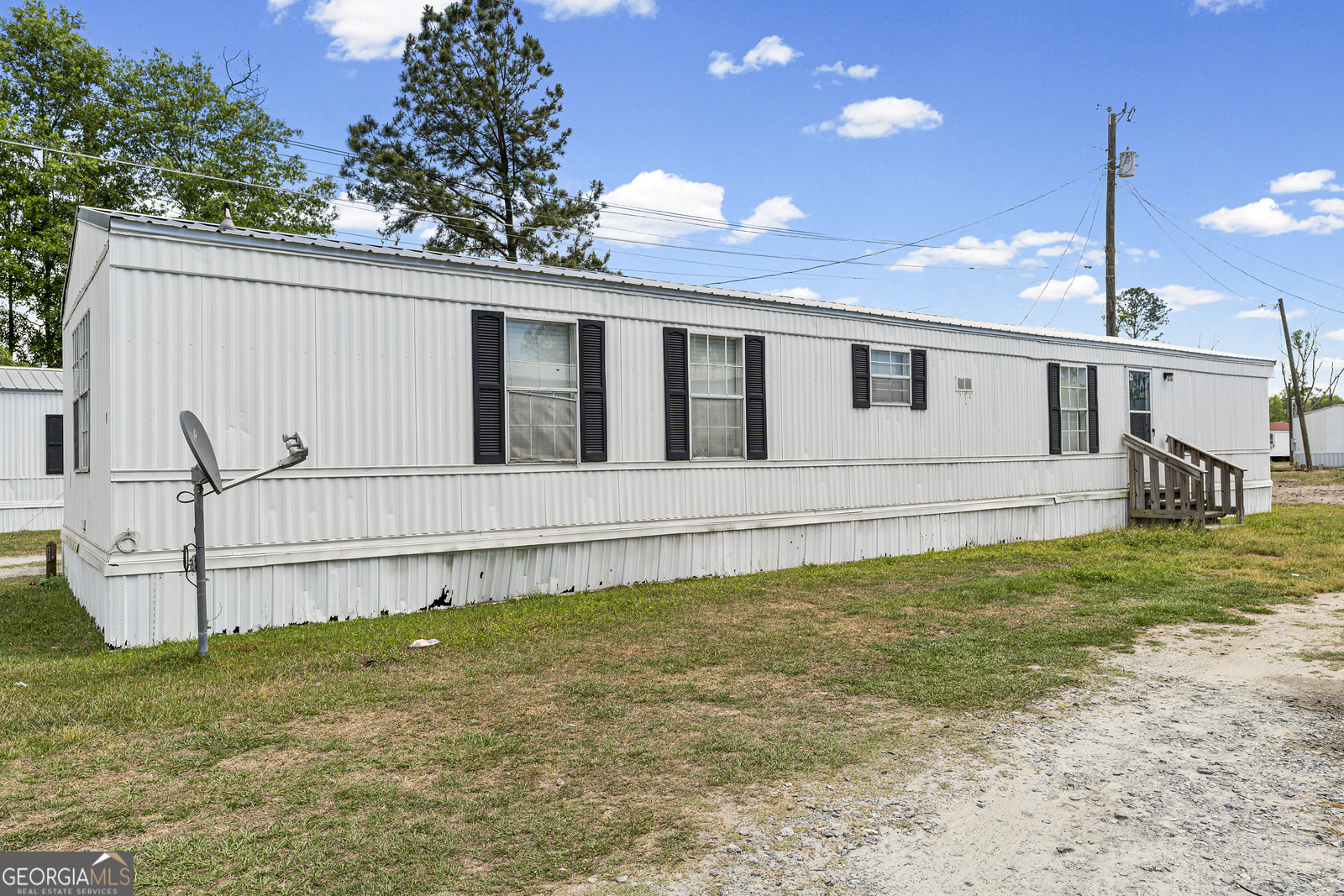 227 Bell Telephone Road Hazlehurst, GA 31539 - Photo 7 of 20 a view of a house with a backyard