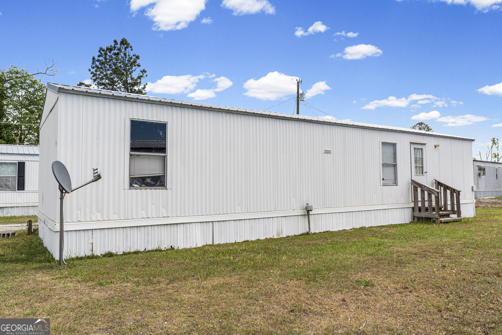 227 Bell Telephone Road Hazlehurst, GA 31539 - Photo 8 of 20 a view of an chairs and table in the backyard
