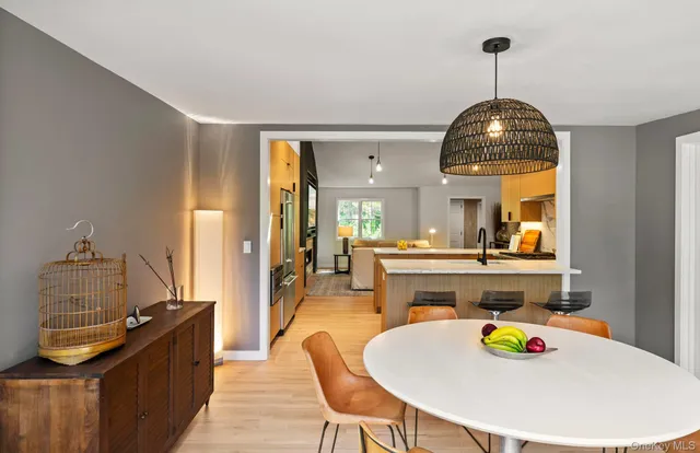 a dining room with fireplace furniture and a chandelier