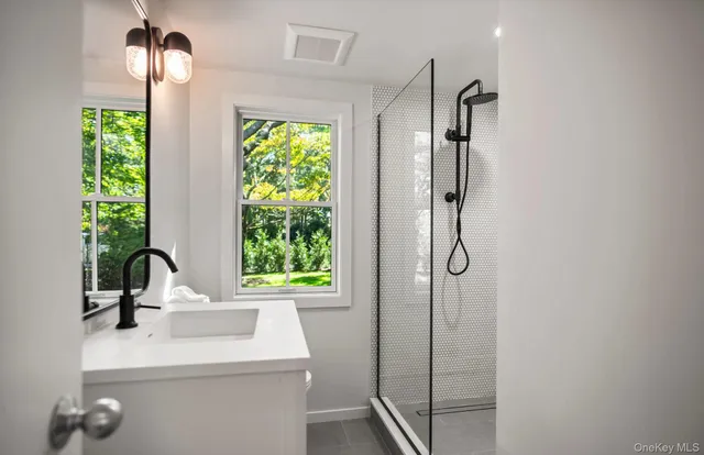 a bathroom with a shower and a sink