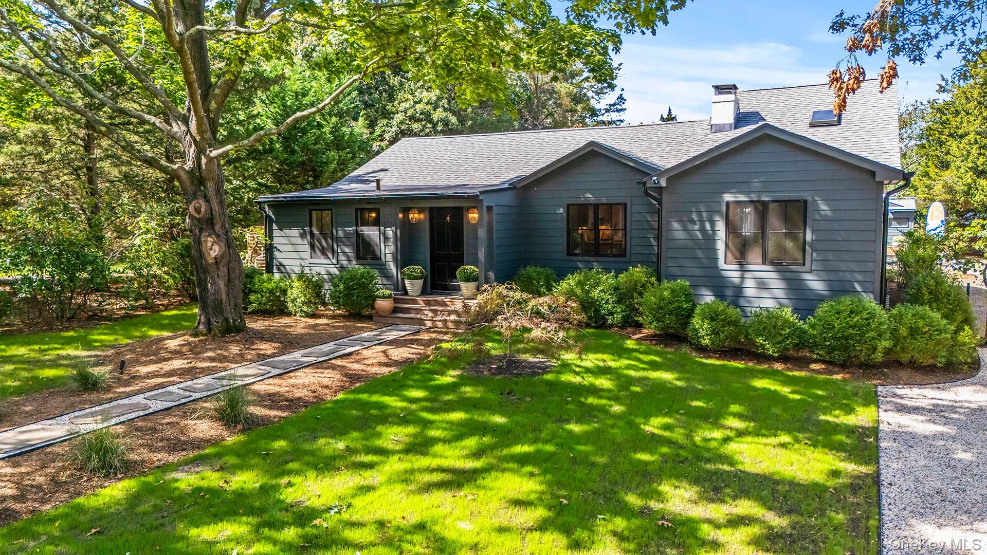 7 Sims Avenue Sag Harbor, NY 11963 - Photo 5 of 30 a front view of a house with a garden