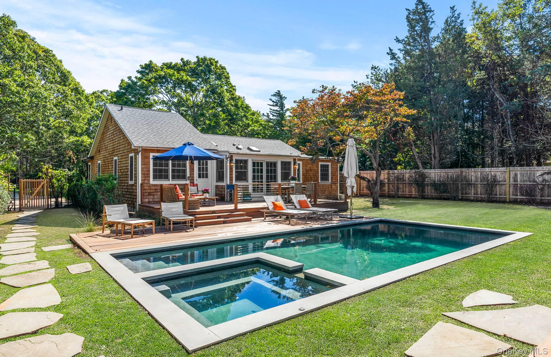 7 Sims Avenue Sag Harbor, NY 11963 - Photo 8 of 30 a view of a swimming pool with chairs and fire pit