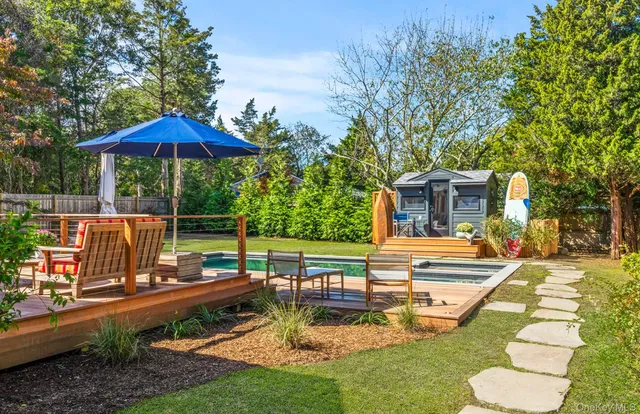 a view of a house with backyard and sitting area