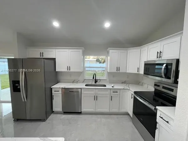 a kitchen with a sink stove and refrigerator