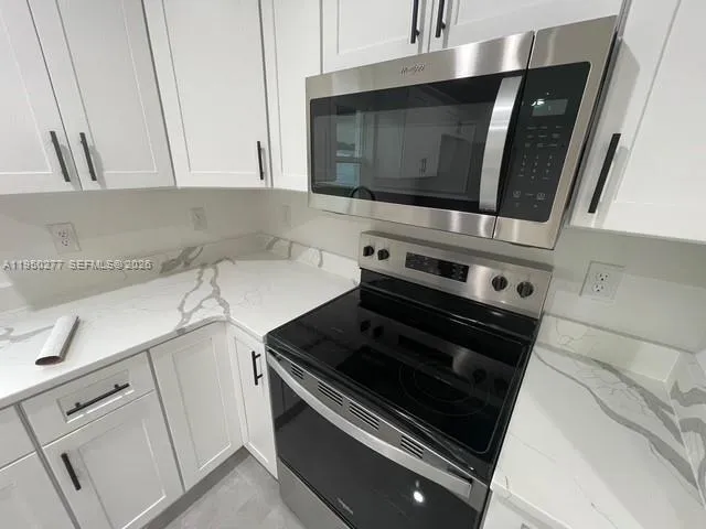 a kitchen with a stove and a microwave