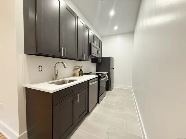 a kitchen with a sink and cabinets