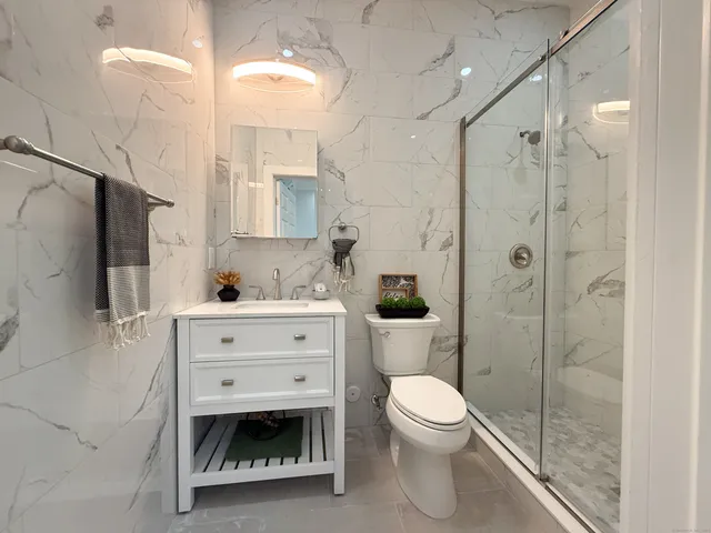 a bathroom with a toilet sink and shower