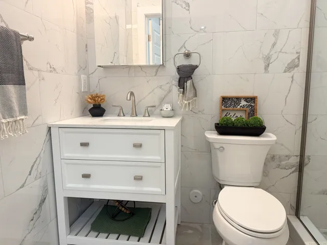 a bathroom with a toilet a sink and a window