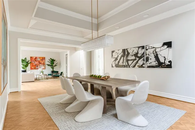 a living room with furniture and painting on the wall