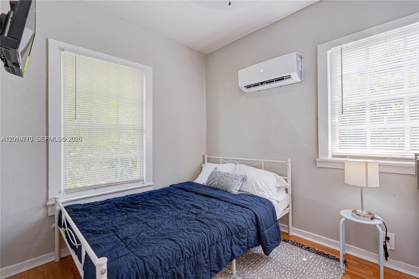 227 Southwest 30th Avenue, Unit B Miami, FL 33135 - Photo 12 of 15 a bedroom with a bed and a window
